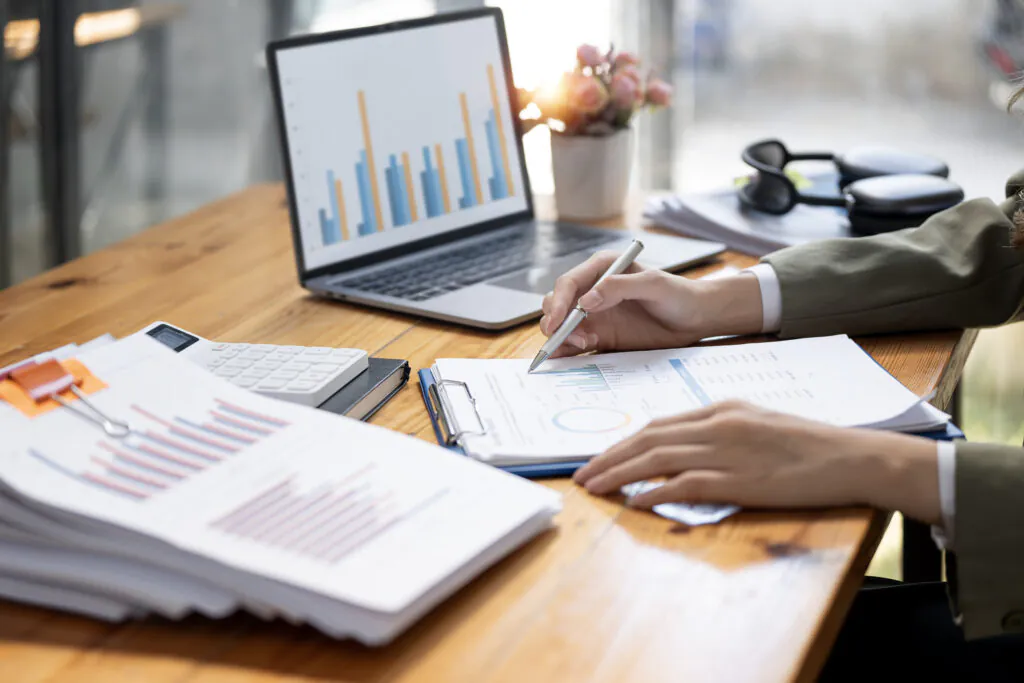 Cropped shot of woman hand working with document while sitting a