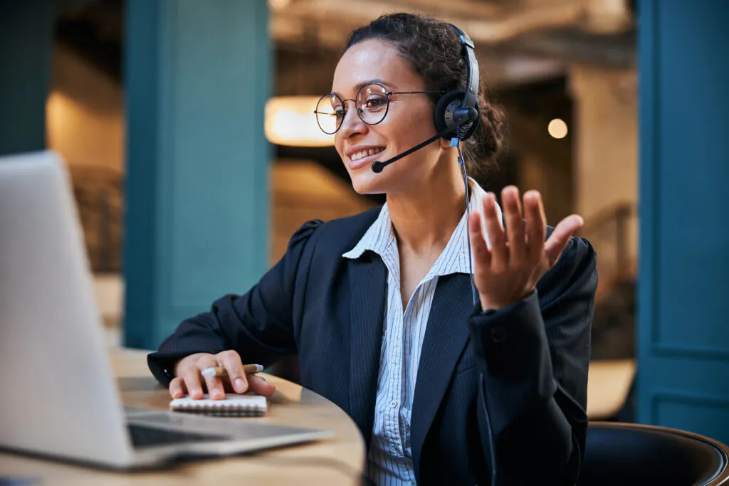 Cute young woman having online video conference